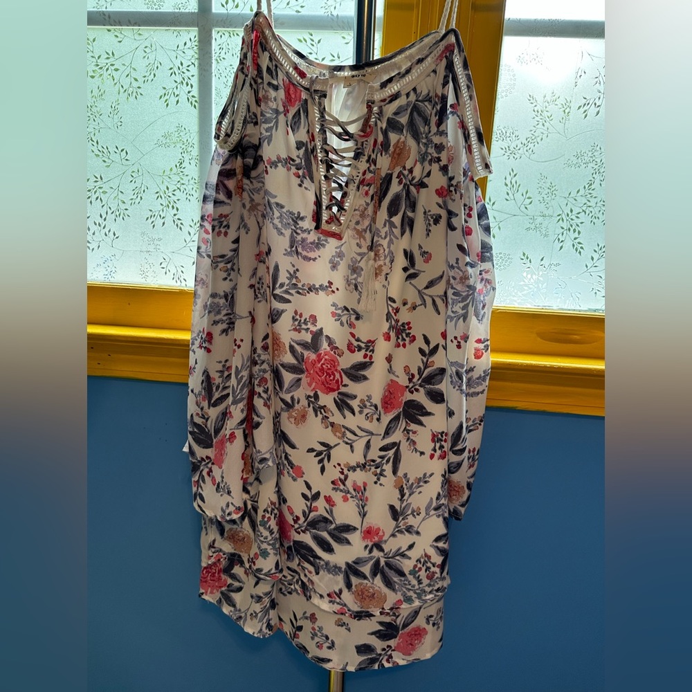 Woman’s large floral open shoulder dress